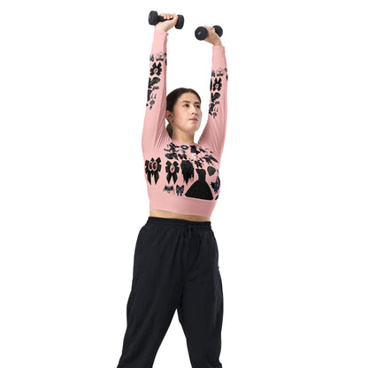 Pink gothic-style women's long sleeve crop top by Eccentric Chemistry with all-over recycled print, shown from the right front.