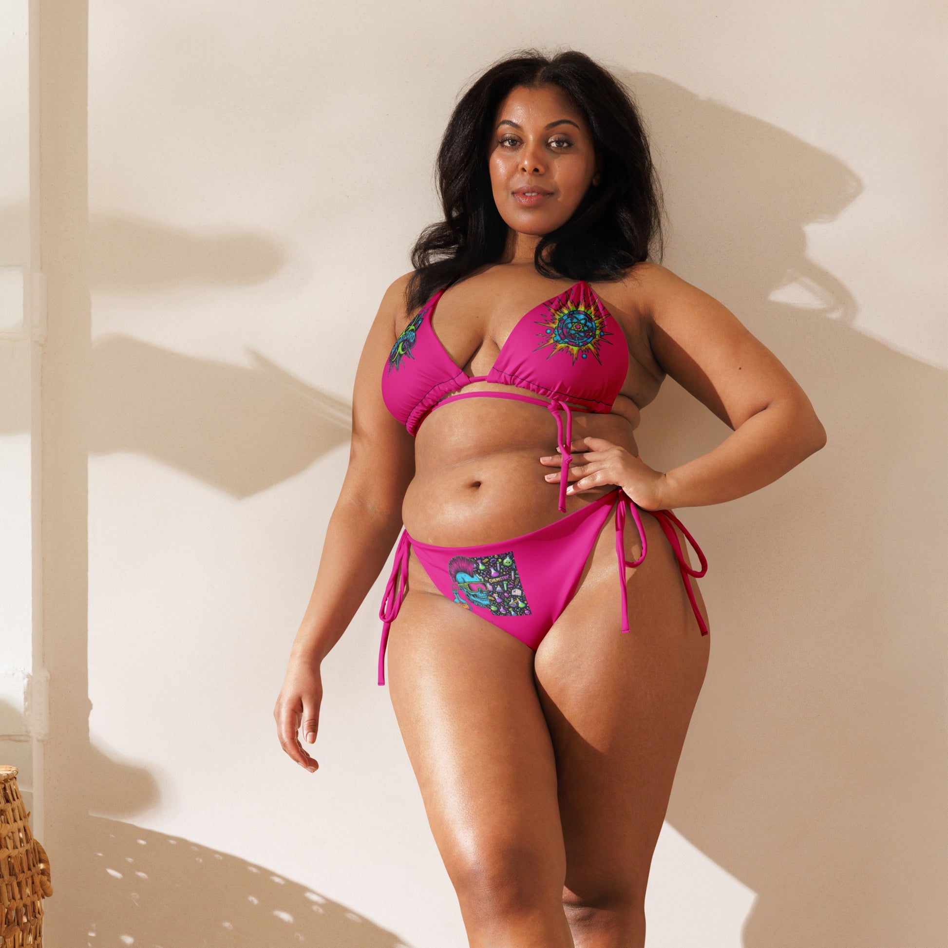 Recycled string bikini with neon fusion experiment print from Mad‑Science collection, showing front view in white with vibrant design.