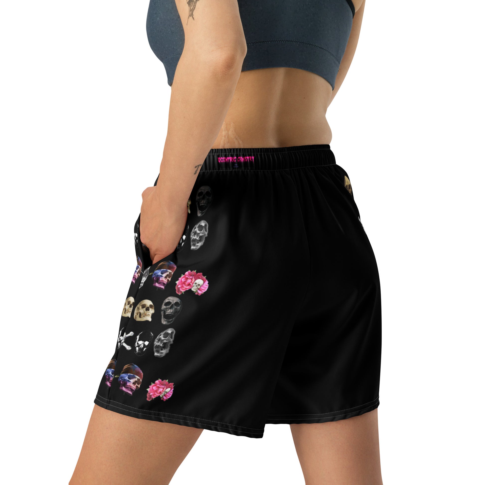 Unisex athletic long shorts with white all-over print featuring skull and impact reactor design by Eccentric Chemistry.