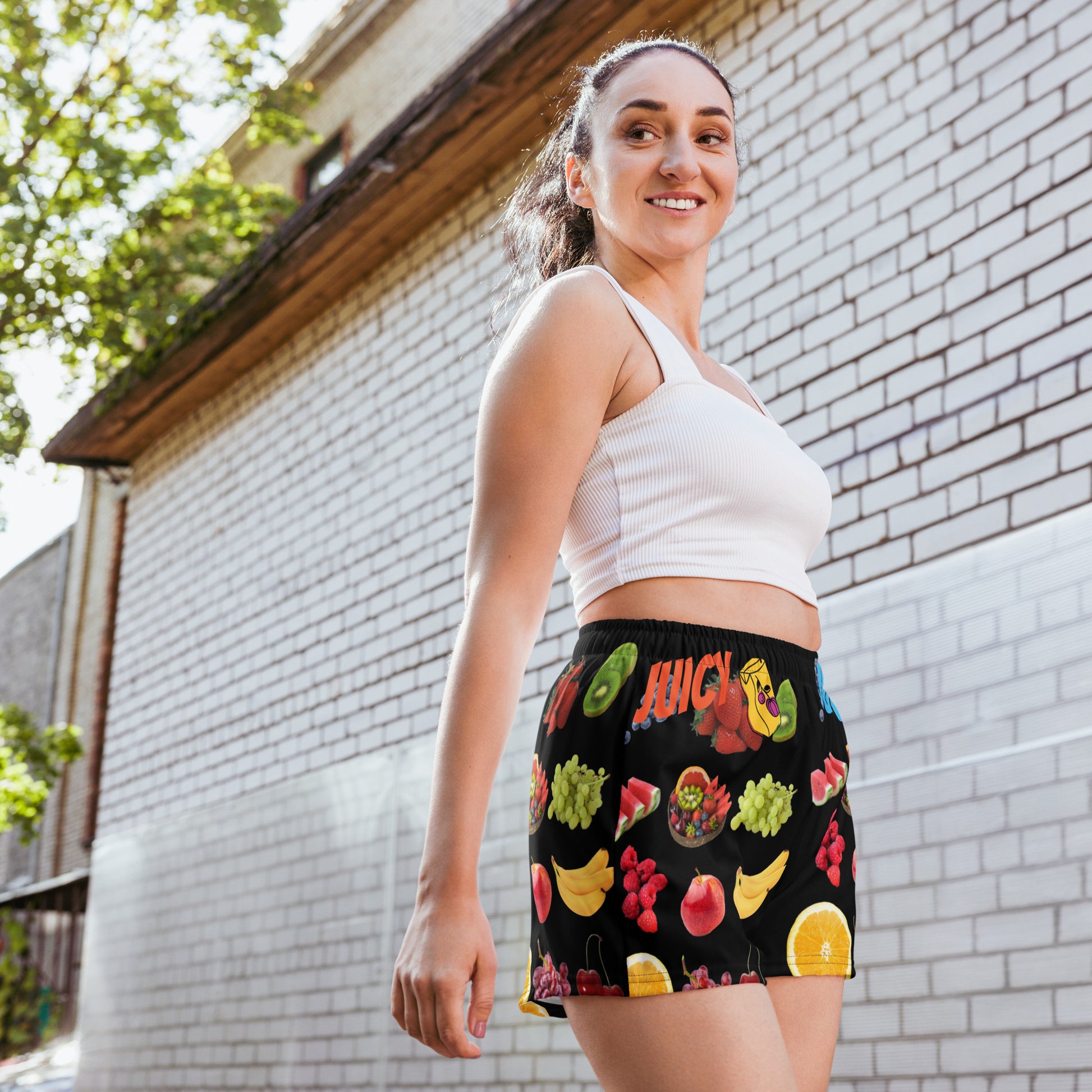 Unisex athletic shorts with a vibrant Juicy Fruit Fusion print, featuring all-over colorful fruit design on white fabric.