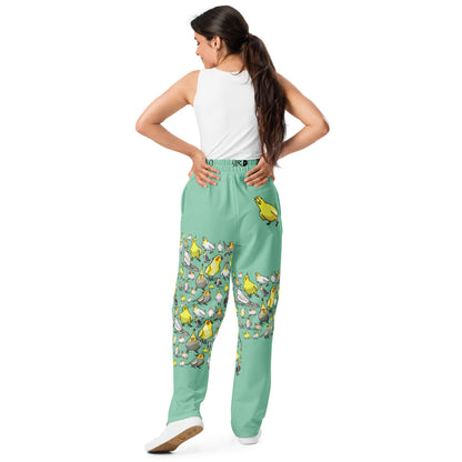 Unisex wide-leg joggers with all-over cockatiel garden print in white, featuring relaxed fit and casual style from Eccentric Chemistry.