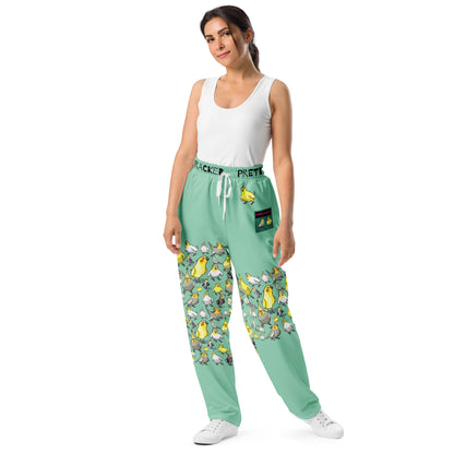 Unisex wide-leg joggers with all-over cockatiel garden breeze print, made by Eccentric Chemistry, featuring a stylish, comfortable cut-sew design.