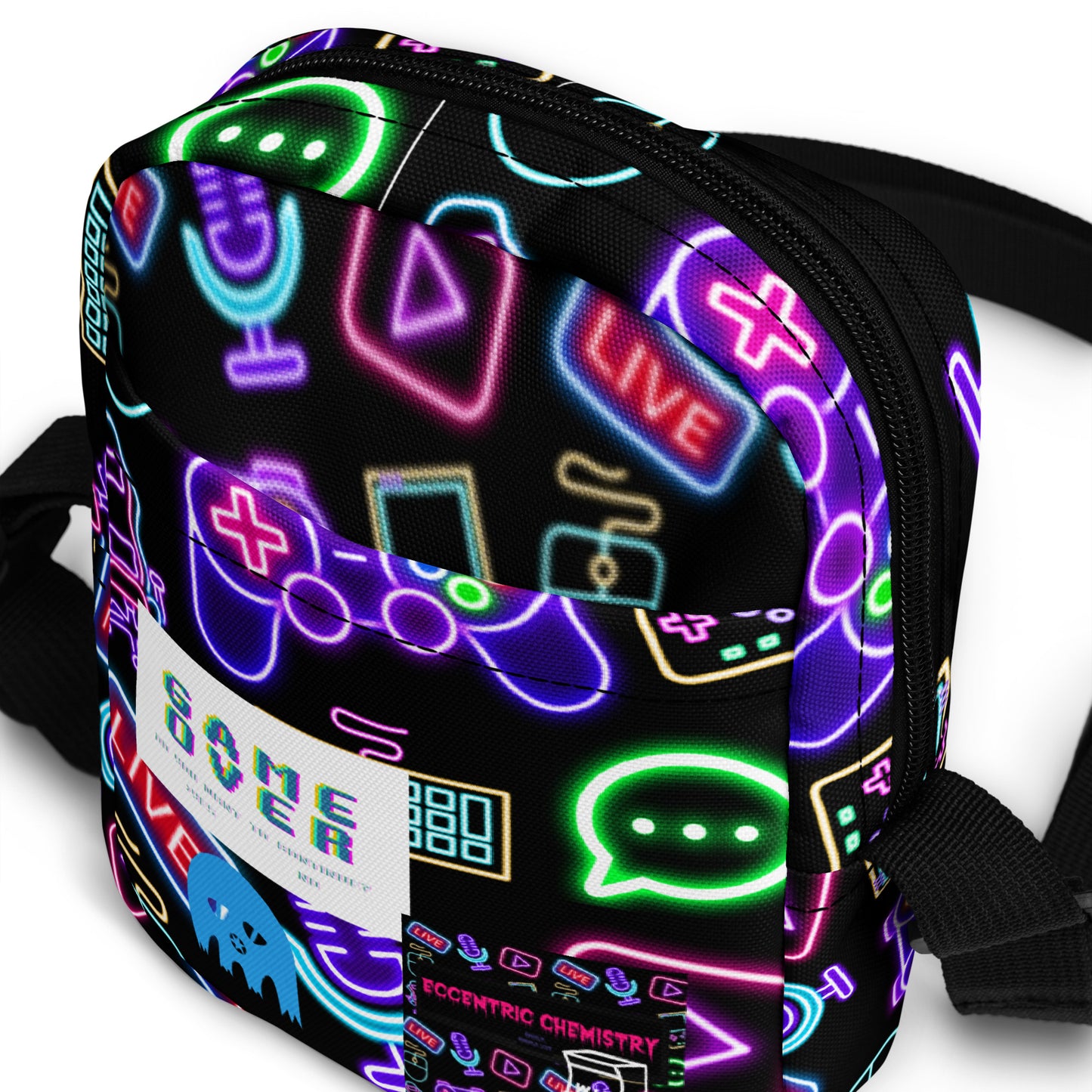 Eccentric Chemistry's Dork-Core Gaming Utility Crossbody Bag with all-over print in white, featuring various gaming-themed designs.