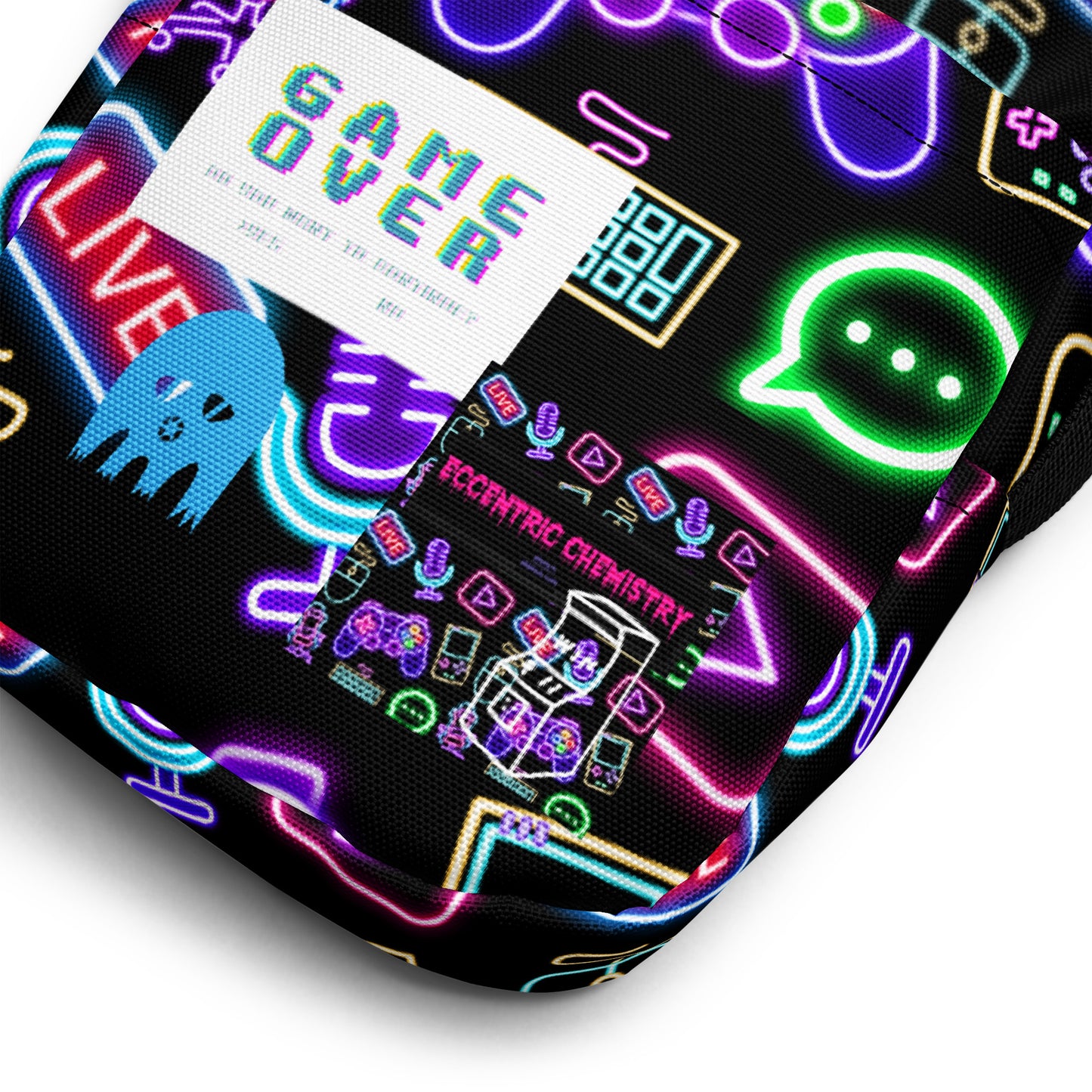 Eccentric Chemistry's Tiny Shop of T-Shirt Horrors utility crossbody bag with all-over gaming print on white fabric.