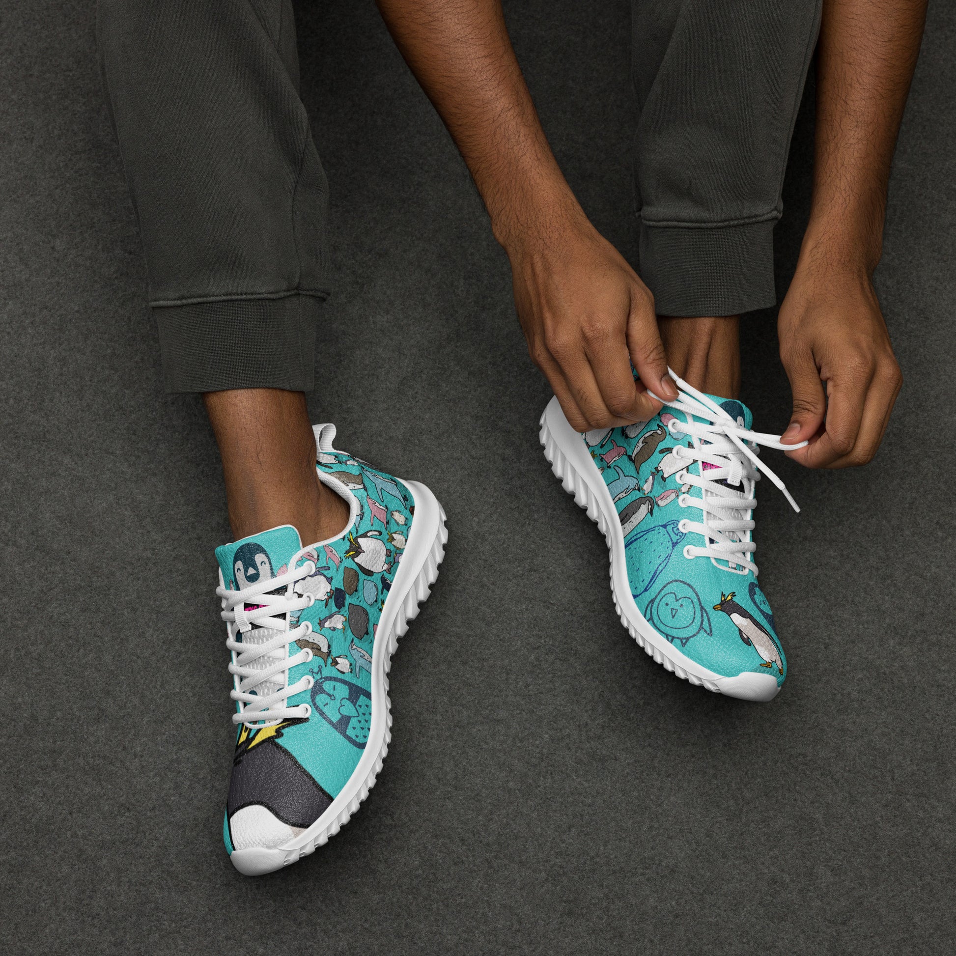 Men’s white athletic shoes from Eccentric Chemistry’s Happy Feet Penguin Experiment collection with laces and sporty design.