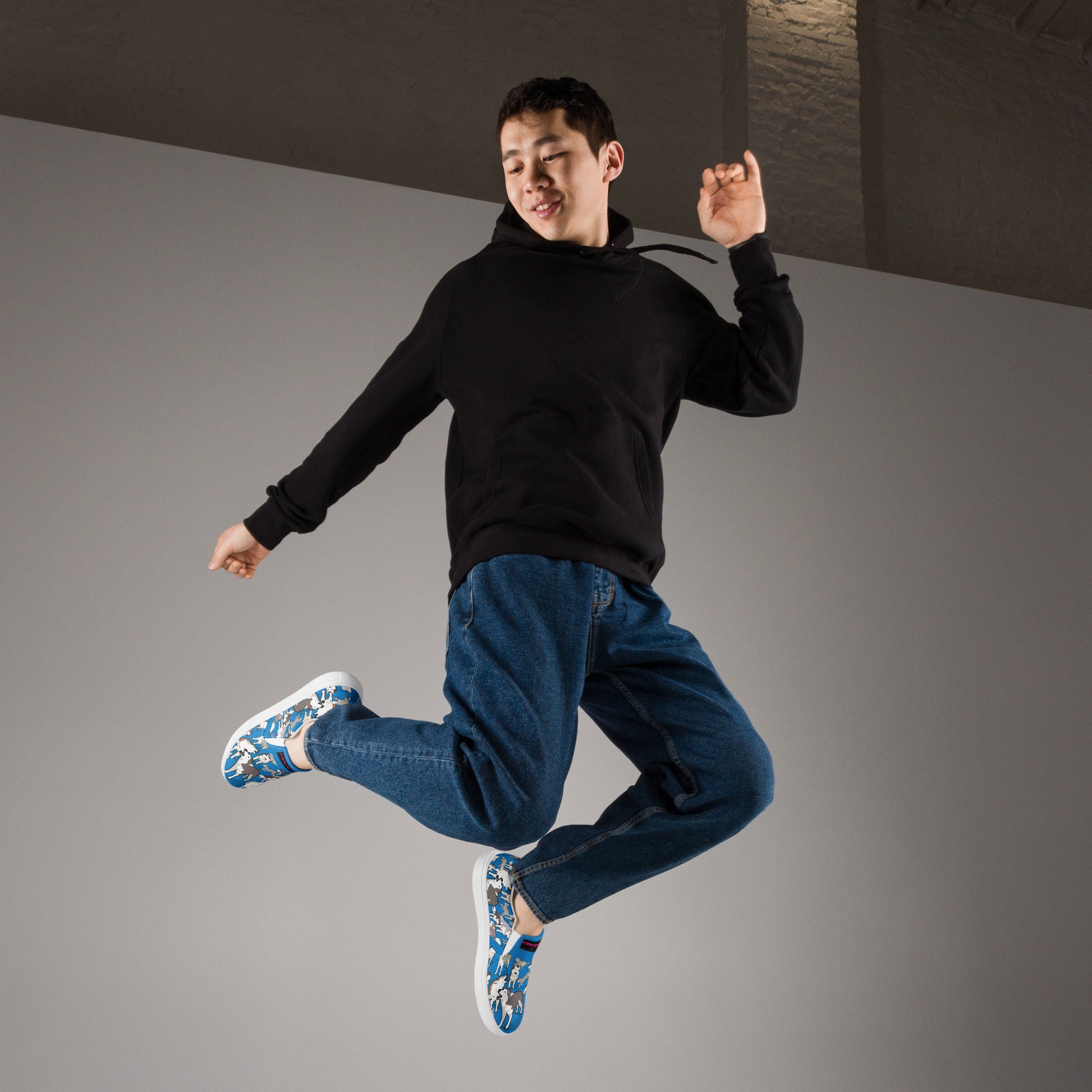 White men's slip-on canvas shoes by Eccentric Chemistry, featuring a sleek design with a front view and comfortable fit.