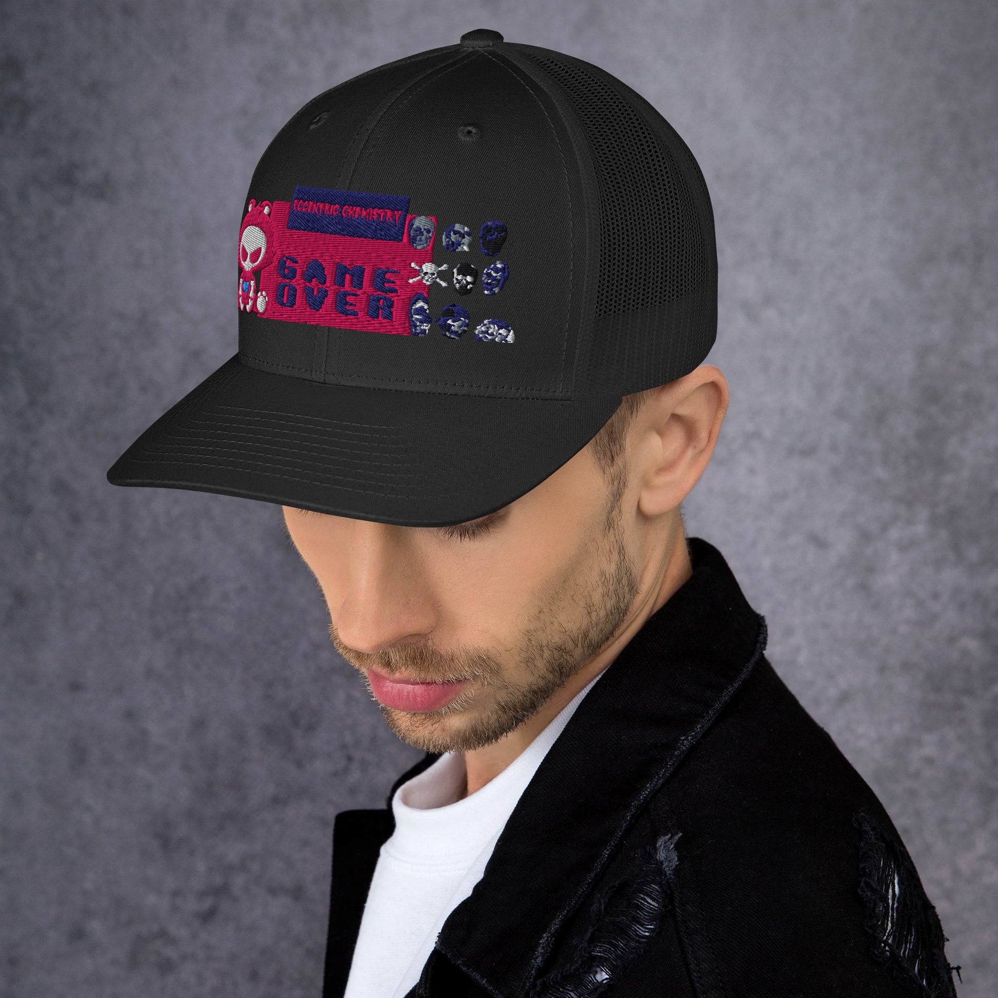 Black pixel panic experiment trucker cap by Eccentric Chemistry with a retro-style mesh and adjustable snapback design.